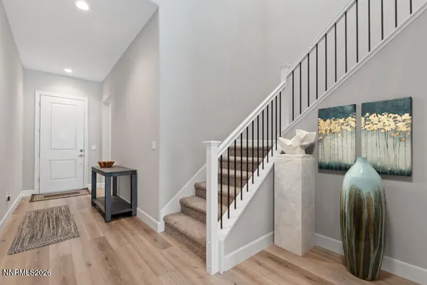 a view of hallway with wooden floor and stairs