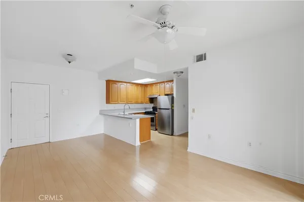 a view of kitchen with sink microwave and cabinets