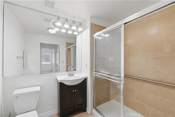 a bathroom with a sink shower and a mirror