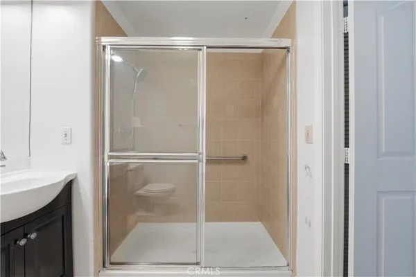 a bathroom with a glass shower door