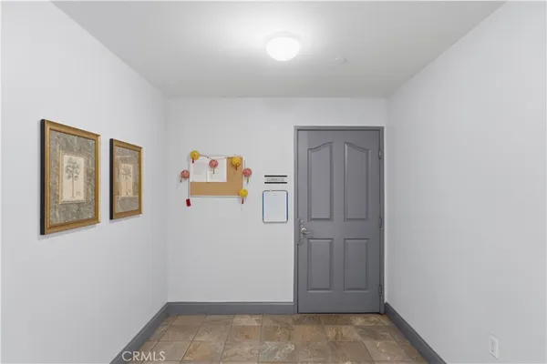 a living room with stainless steel appliances furniture and a kitchen view