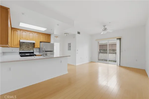 a view of kitchen with wooden floor and electronic appliances