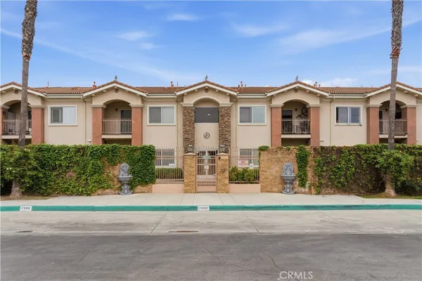 a view of a building with garden and sitting area