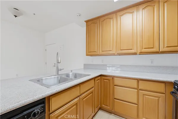 a kitchen with a sink cabinets and wooden floor