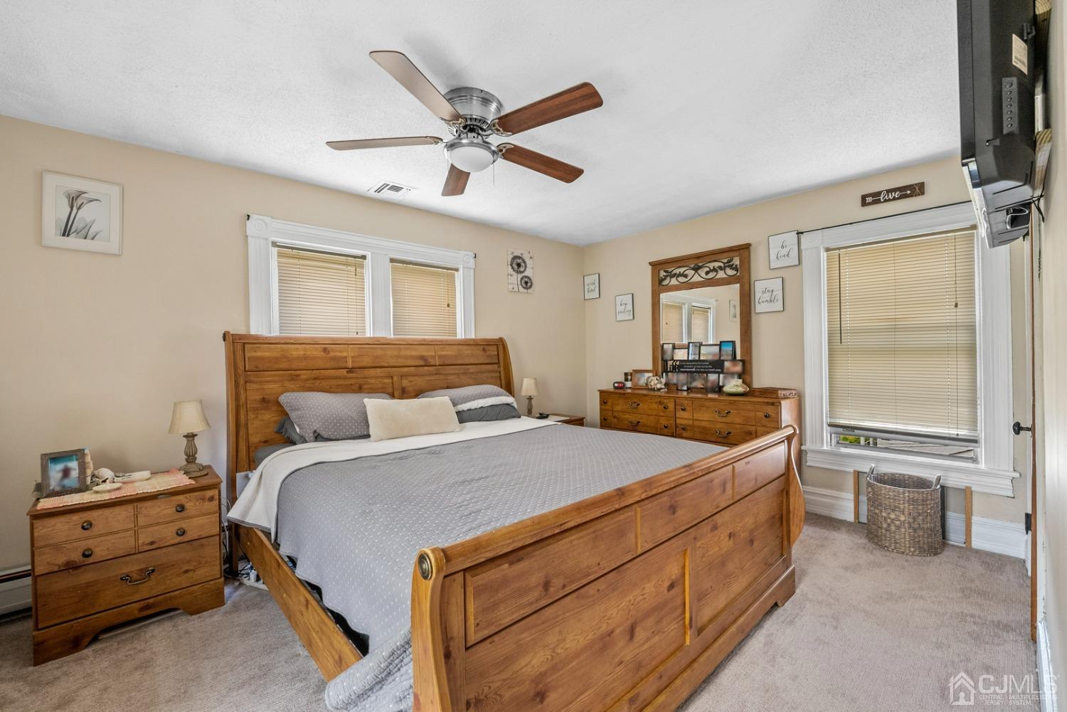 35 Tennent Road Morganville, NJ 07751 - Photo 50 of 57 a bedroom with a bed and a chandelier