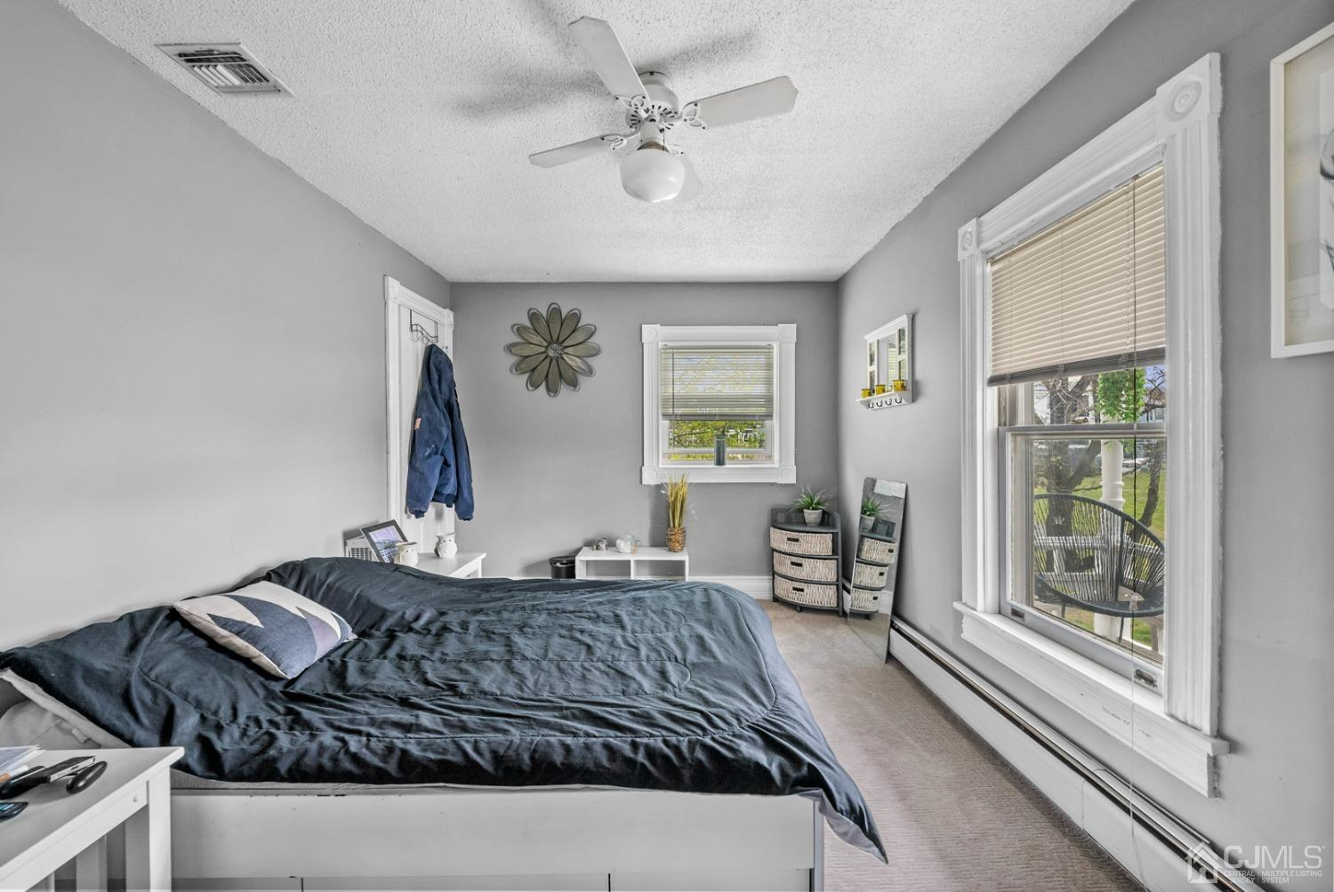 35 Tennent Road Morganville, NJ 07751 - Photo 54 of 57 a bedroom with a large bed and windows