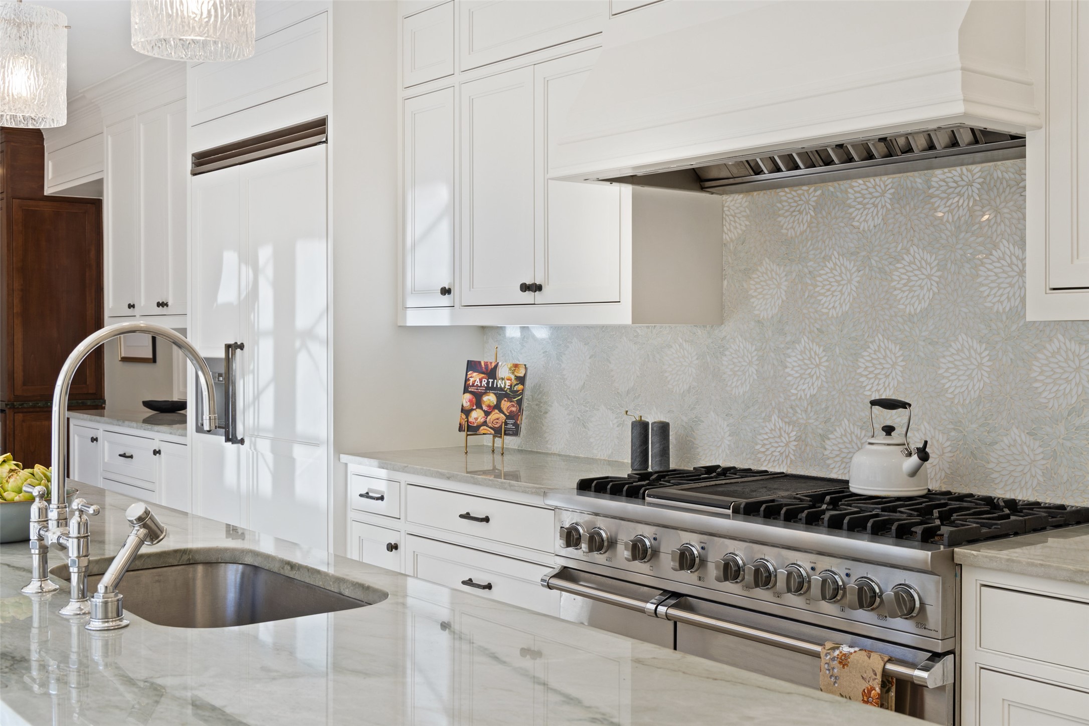 1810 West 35th Street Austin, TX 78703 - Photo 14 of 40 Kitchen with custom range hood, high end appliances, white cabinets, and light stone countertops