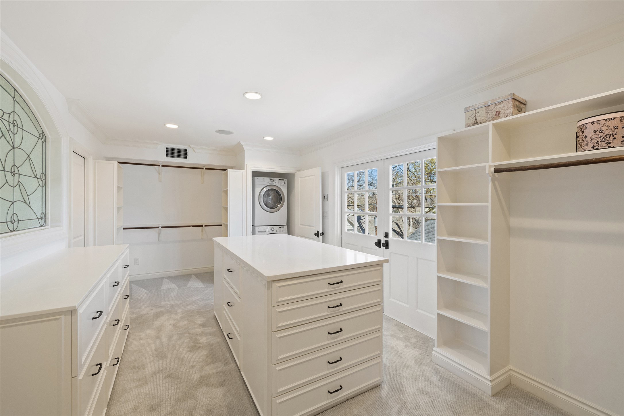 1810 West 35th Street Austin, TX 78703 - Photo 24 of 40 This expansive master closet offers separate wardrobe areas, a grand central island, and custom inserts for jewelry,
watches, and cufflinks. A built-in washer and dryer add everyday convenience to this refined dressing retreat.
