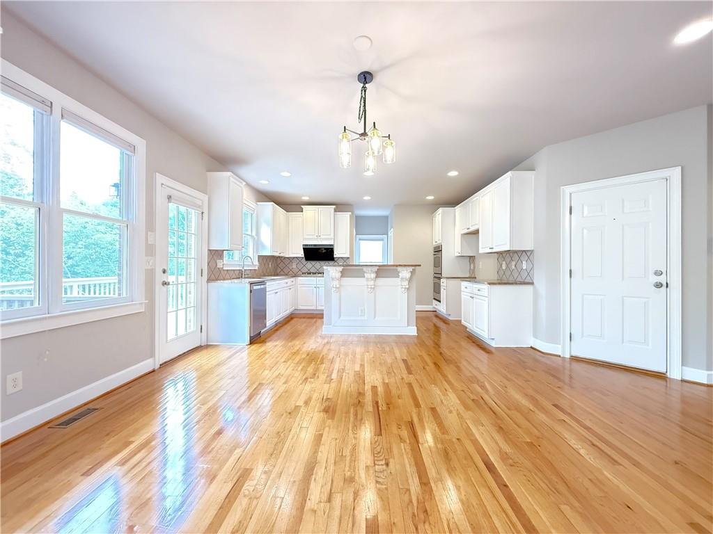 3500 Millwater Crossing Northeast Dacula, GA 30019 - Photo 12 of 72 a large kitchen with cabinets wooden floor and stainless steel appliances