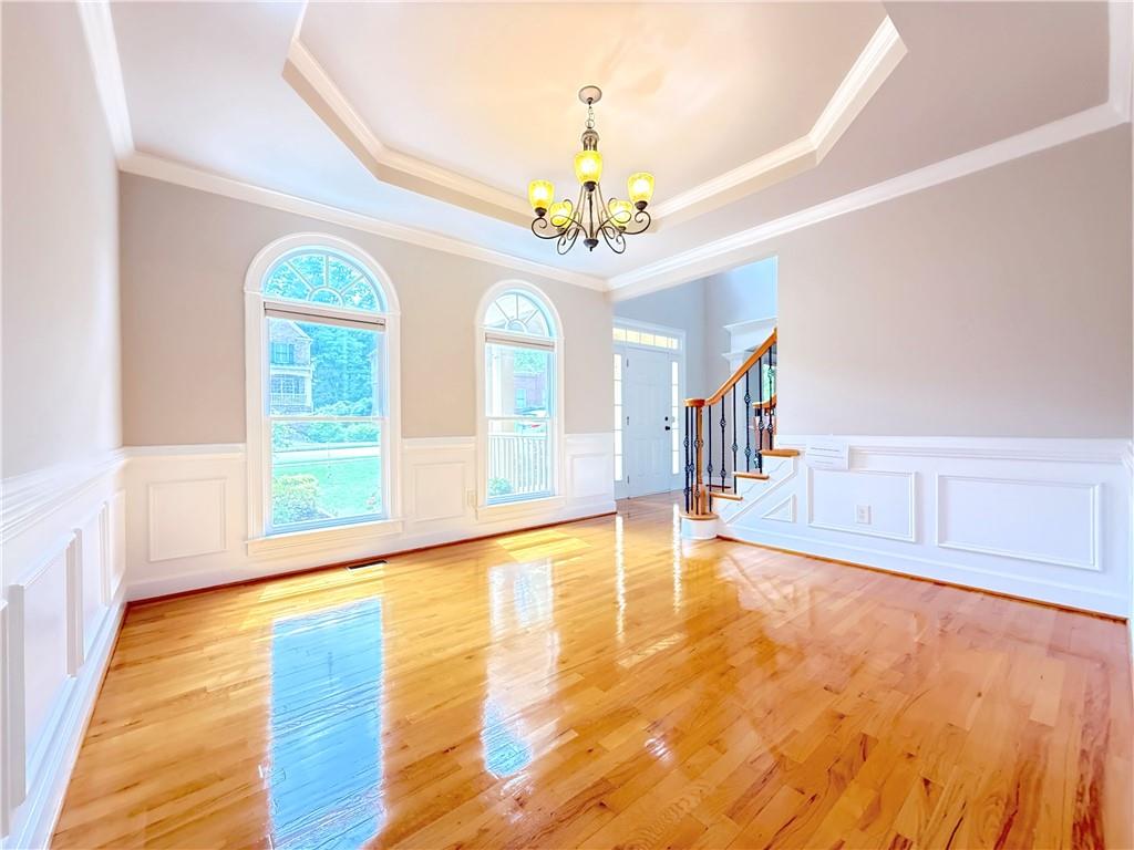 3500 Millwater Crossing Northeast Dacula, GA 30019 - Photo 14 of 72 a view of an room with chandelier fan and wooden floor