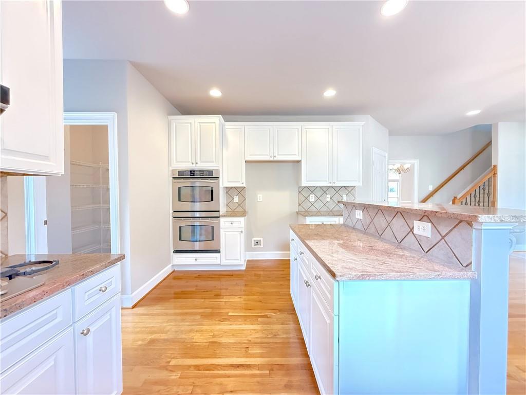 3500 Millwater Crossing Northeast Dacula, GA 30019 - Photo 19 of 72 a large kitchen with kitchen island a stove a sink and a refrigerator