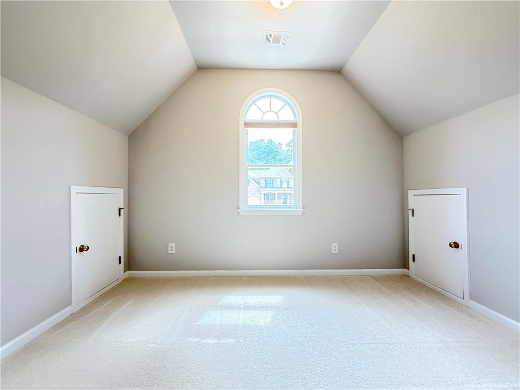 3500 Millwater Crossing Northeast Dacula, GA 30019 - Photo 29 of 72 an empty room with a window and a mirror