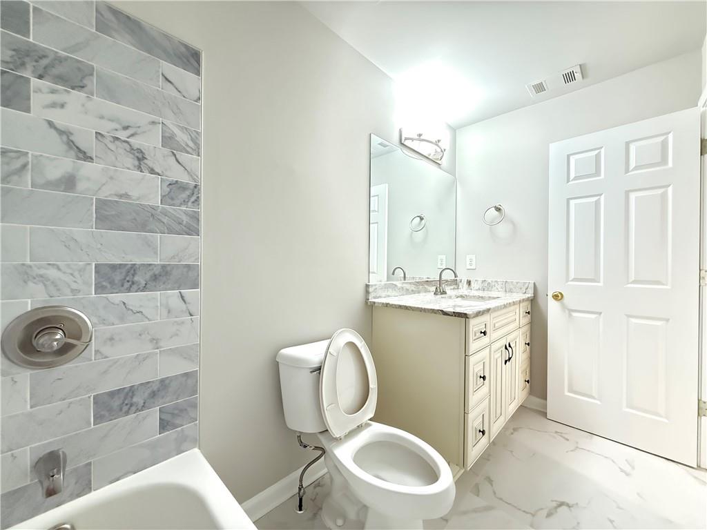 3500 Millwater Crossing Northeast Dacula, GA 30019 - Photo 48 of 72 a bathroom with a toilet sink and mirror