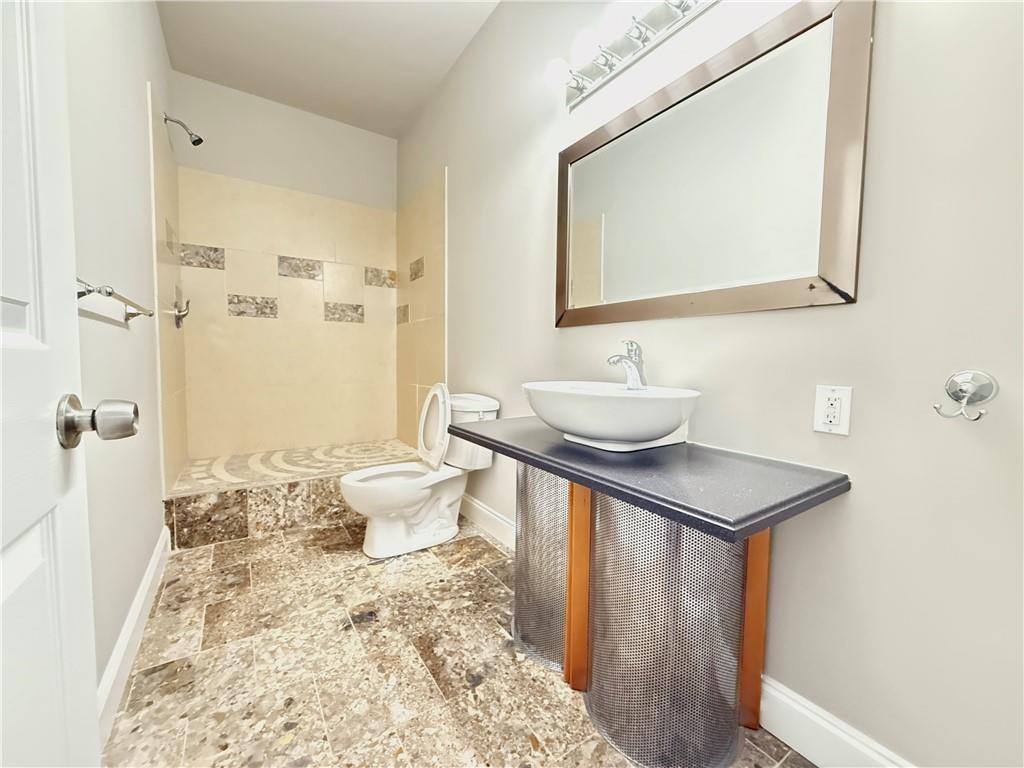 3500 Millwater Crossing Northeast Dacula, GA 30019 - Photo 50 of 72 a bathroom with a sink toilet and shower