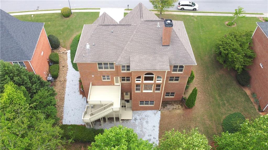 3500 Millwater Crossing Northeast Dacula, GA 30019 - Photo 66 of 72 an aerial view of a house with outdoor space and a lake view