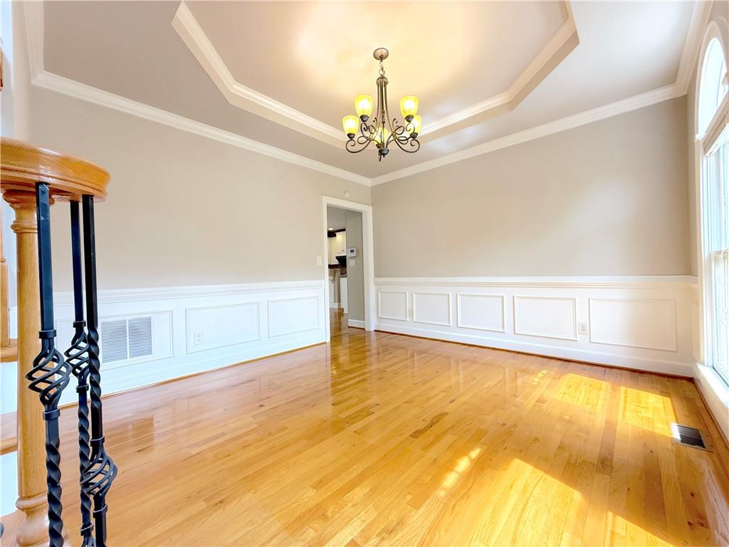 3500 Millwater Crossing Northeast Dacula, GA 30019 - Photo 7 of 72 a view of empty room with window and wooden floor