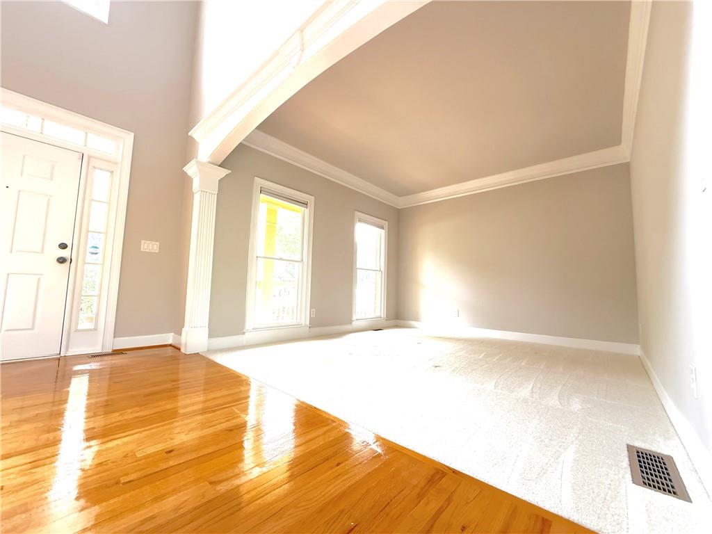 3500 Millwater Crossing Northeast Dacula, GA 30019 - Photo 9 of 72 a view of an empty room with wooden floor and a window