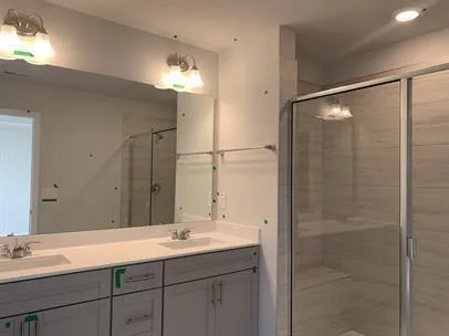 a bathroom with a double vanity sink and a mirror