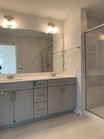 a bathroom with a double vanity sink and a mirror