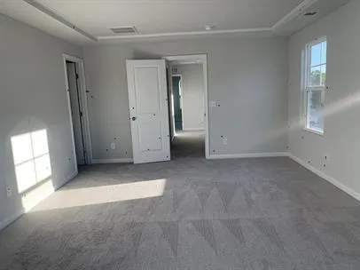 an empty room with windows and closet