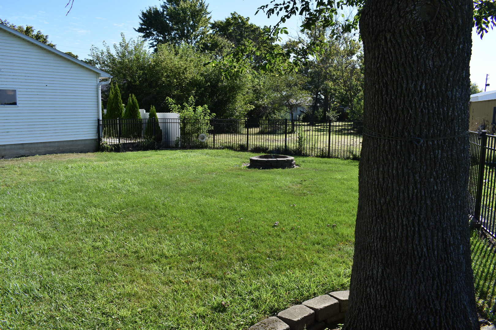 403 East Elm Street Buckley, IL 60918 - Photo 18 of 20 a view of a backyard with wooden fence and a bench