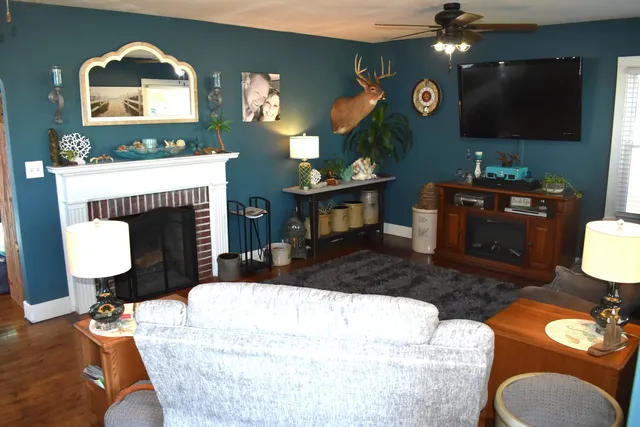 a living room with furniture and a fireplace