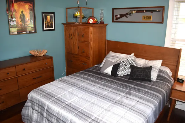 a bedroom with a bed and a window