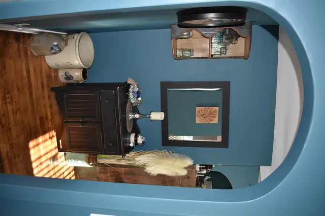 a room with a mirror and a lamp