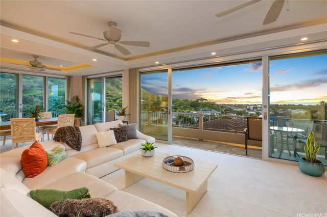 a living room with furniture and a floor to ceiling window