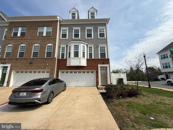 a view of a car parked in front of a brick house
