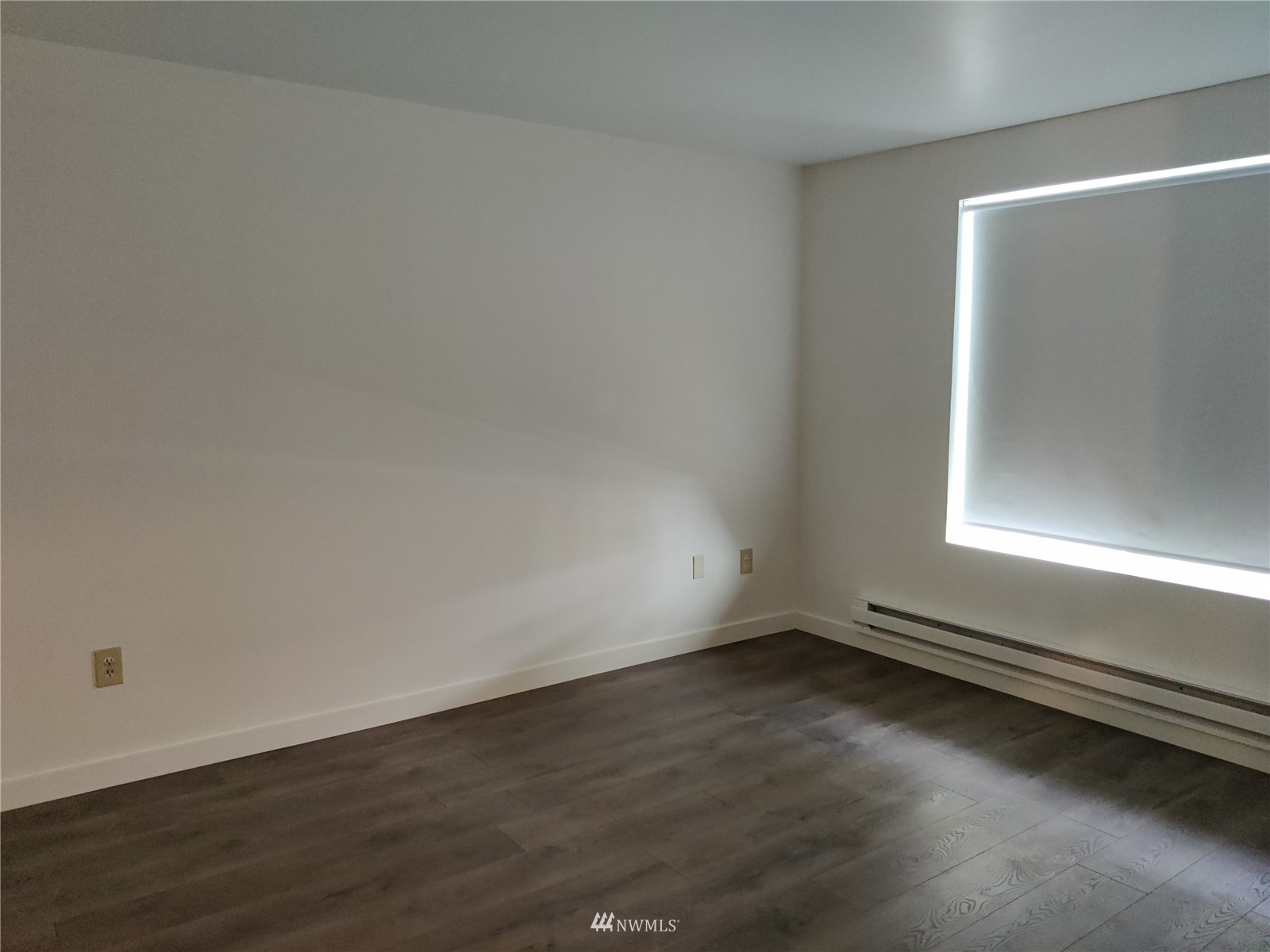 4308 Northeast Sunset Boulevard, Unit Z2 Renton, WA 98059 - Photo 6 of 6 an empty room with wooden floor and windows