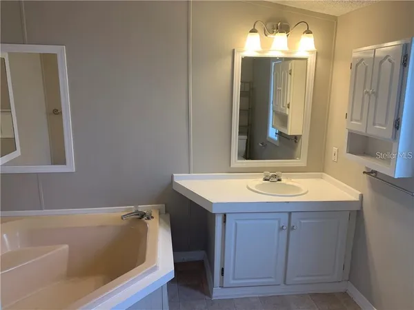 a bathroom with a tub and shower