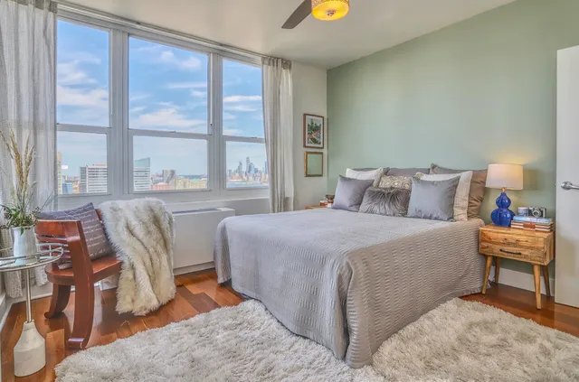 a bedroom with a bed and a large window