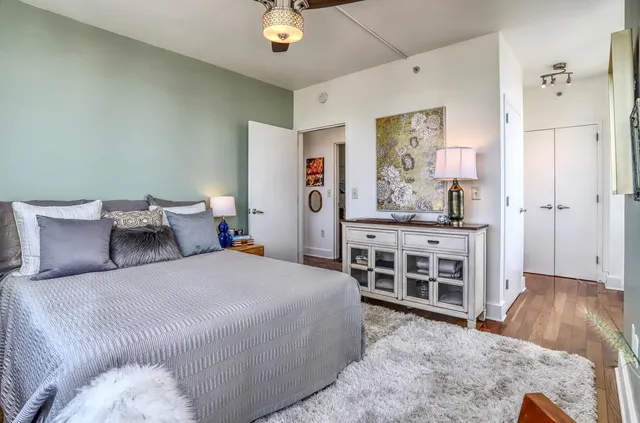 a bedroom with a bed and a wooden floor