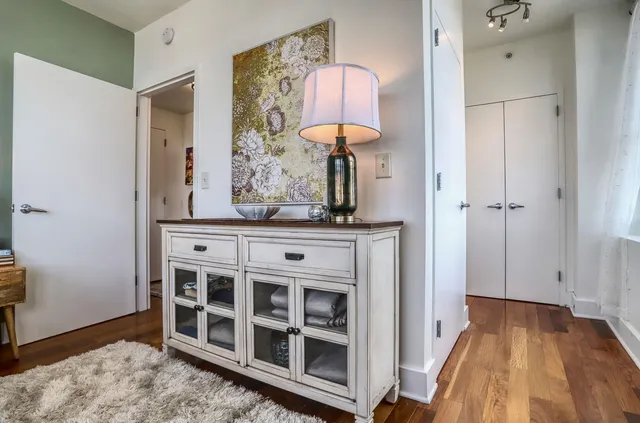 a view of a hallway with entryway wooden floor and front door