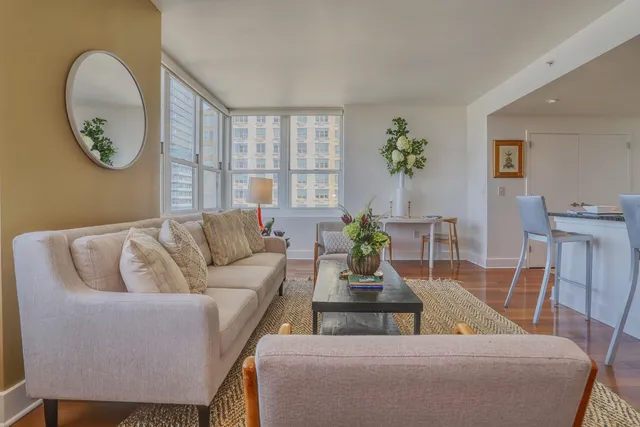 a living room with furniture flowerpot and window