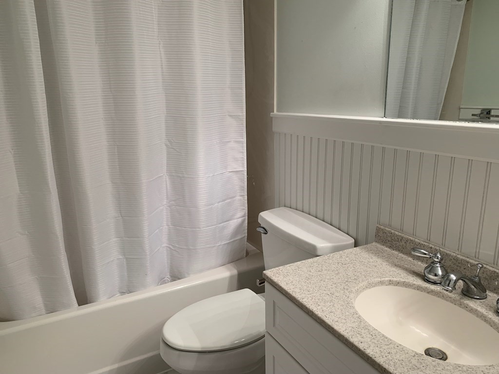 43 West Street Beverly, MA 01915 - Photo 11 of 15 a bathroom with a granite countertop sink toilet and a mirror