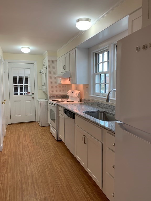 43 West Street Beverly, MA 01915 - Photo 3 of 15 a kitchen with sink cabinets and wooden floor