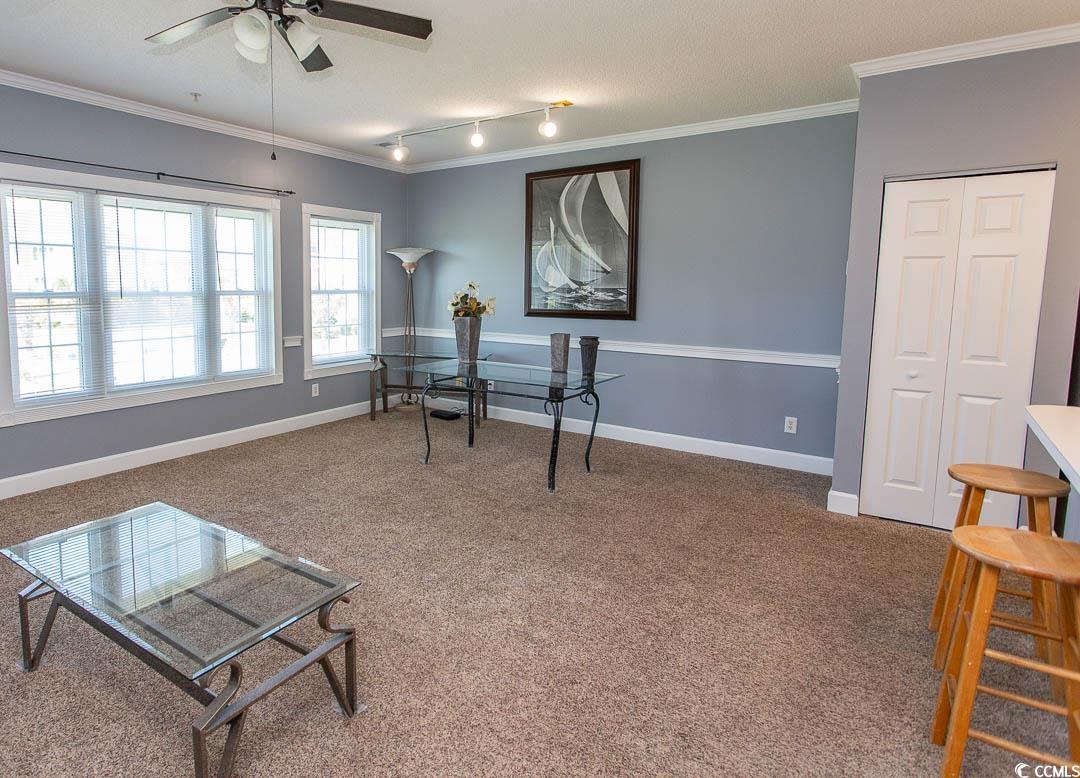 4823 Orchid Way, Unit 2203 Myrtle Beach, SC 29577 - Photo 13 of 36 Living area with carpet, crown molding, and ceiling fan