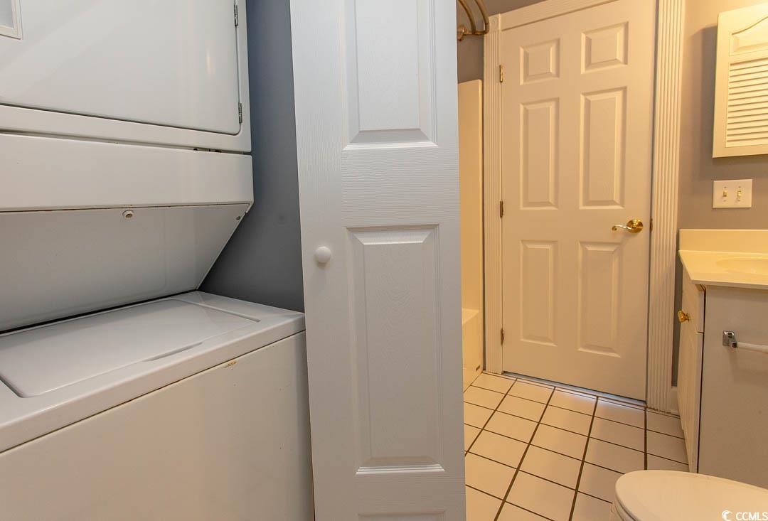 4823 Orchid Way, Unit 2203 Myrtle Beach, SC 29577 - Photo 20 of 36 Washroom with stacked washer and clothes dryer, laundry area, and light tile patterned floors