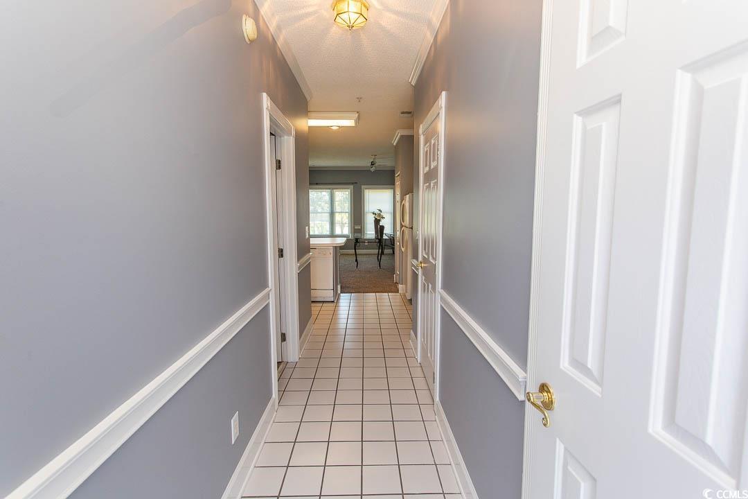4823 Orchid Way, Unit 2203 Myrtle Beach, SC 29577 - Photo 2 of 36 Hallway with baseboards and light tile patterned flooring