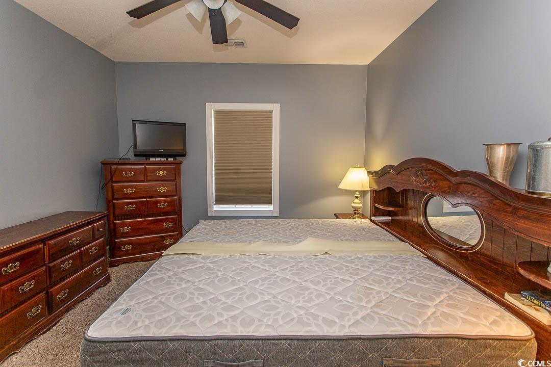 4823 Orchid Way, Unit 2203 Myrtle Beach, SC 29577 - Photo 21 of 36 Bedroom with a ceiling fan, visible vents, and carpet