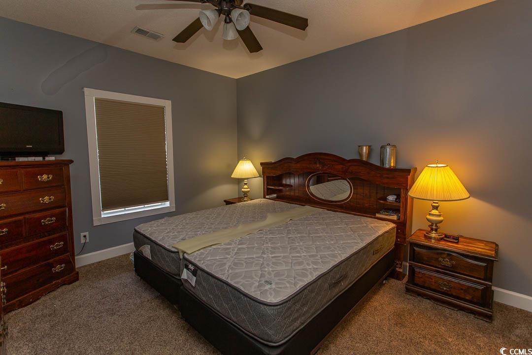 4823 Orchid Way, Unit 2203 Myrtle Beach, SC 29577 - Photo 22 of 36 Carpeted bedroom featuring ceiling fan, baseboards, and visible vents