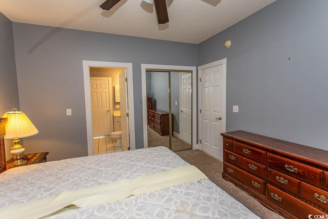 4823 Orchid Way, Unit 2203 Myrtle Beach, SC 29577 - Photo 24 of 36 Bedroom featuring carpet, ensuite bath, a ceiling fan, and baseboards