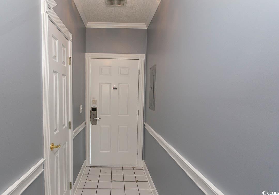 4823 Orchid Way, Unit 2203 Myrtle Beach, SC 29577 - Photo 3 of 36 Doorway to outside with a textured ceiling, baseboards, visible vents, crown molding, and light tile patterned floors
