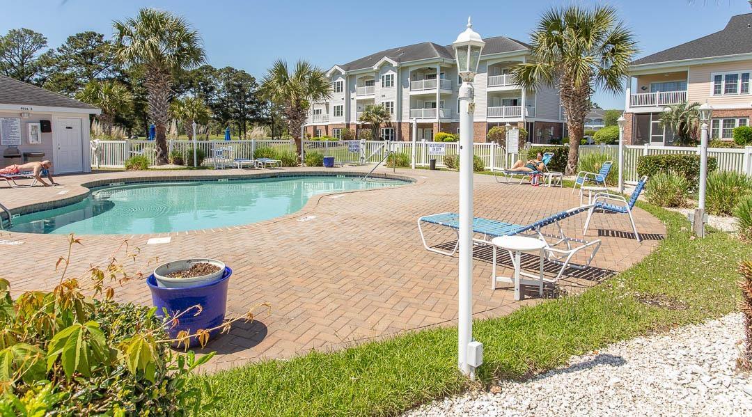4823 Orchid Way, Unit 2203 Myrtle Beach, SC 29577 - Photo 33 of 36 Community pool featuring a patio and fence