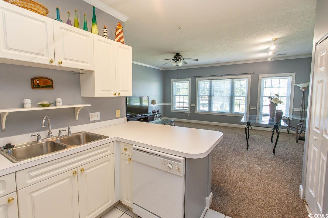 4823 Orchid Way, Unit 2203 Myrtle Beach, SC 29577 - Photo 6 of 36 Kitchen featuring a ceiling fan, crown molding, white dishwasher, a sink, and a peninsula