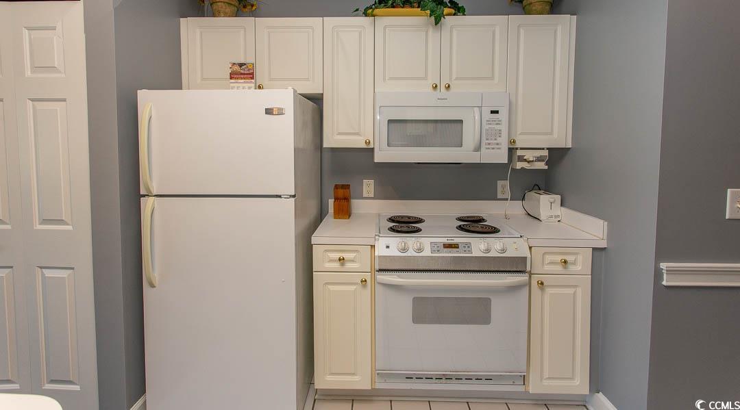 4823 Orchid Way, Unit 2203 Myrtle Beach, SC 29577 - Photo 8 of 36 Kitchen with white cabinets, white appliances, and light countertops