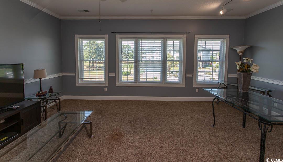 4823 Orchid Way, Unit 2203 Myrtle Beach, SC 29577 - Photo 10 of 36 Carpeted living area with rail lighting, visible vents, baseboards, and ornamental molding