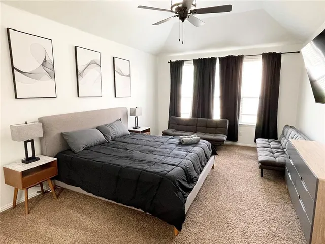 a bedroom with bed and window